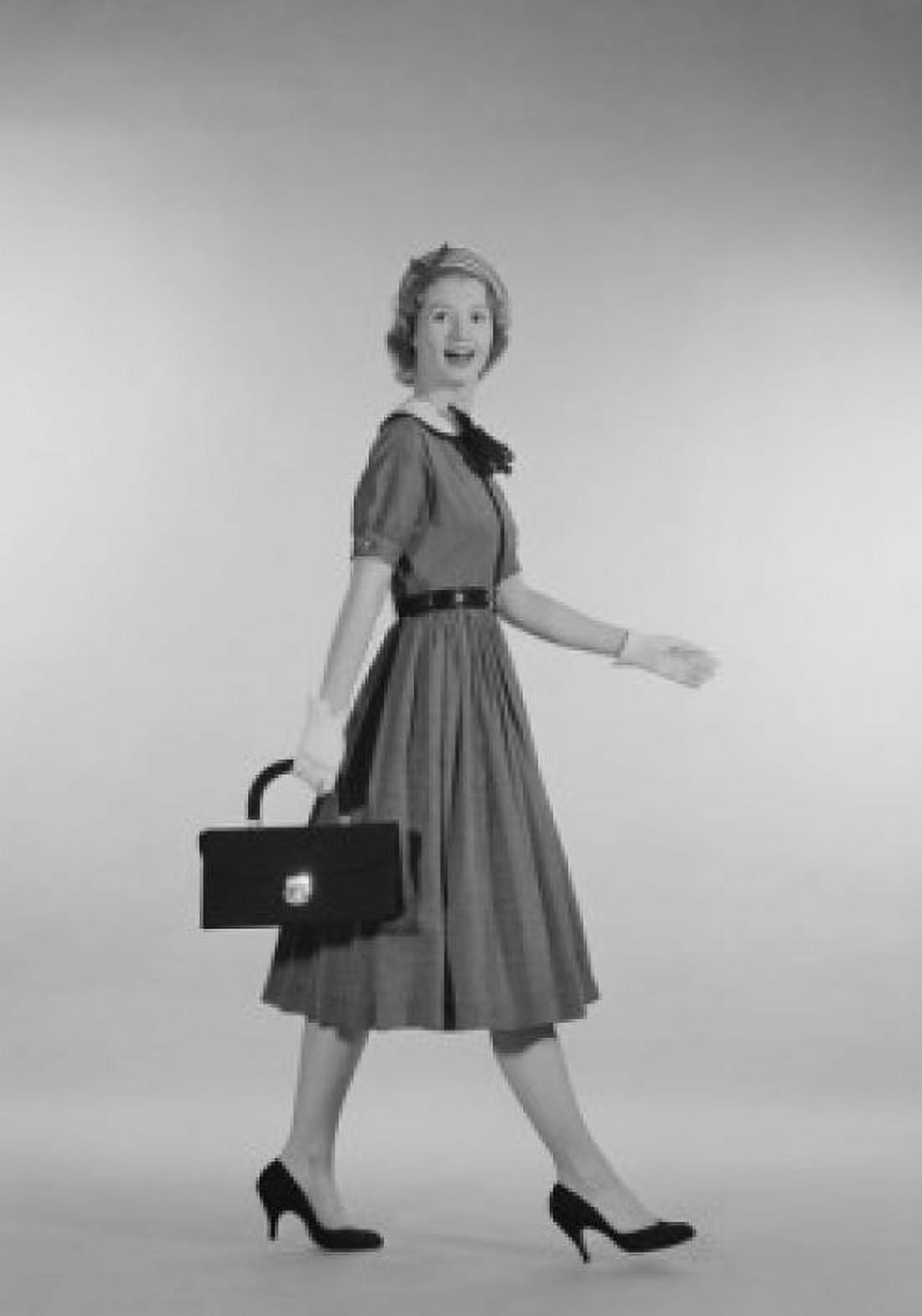 Young woman carrying suitcase Canvas Art - (18 x 24)