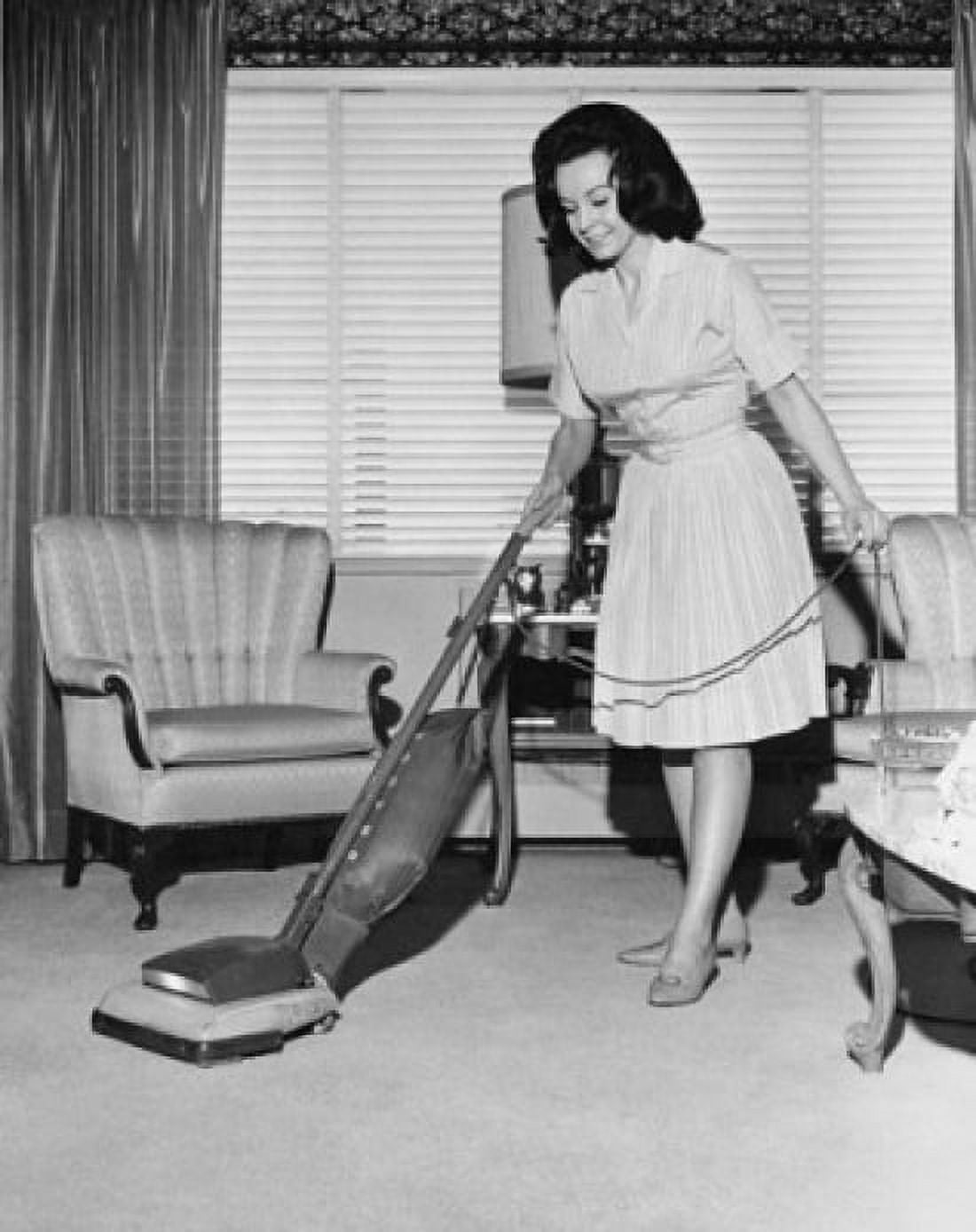 Young woman cleaning carpet with a vacuum cleaner Canvas Art - (18 x 24)