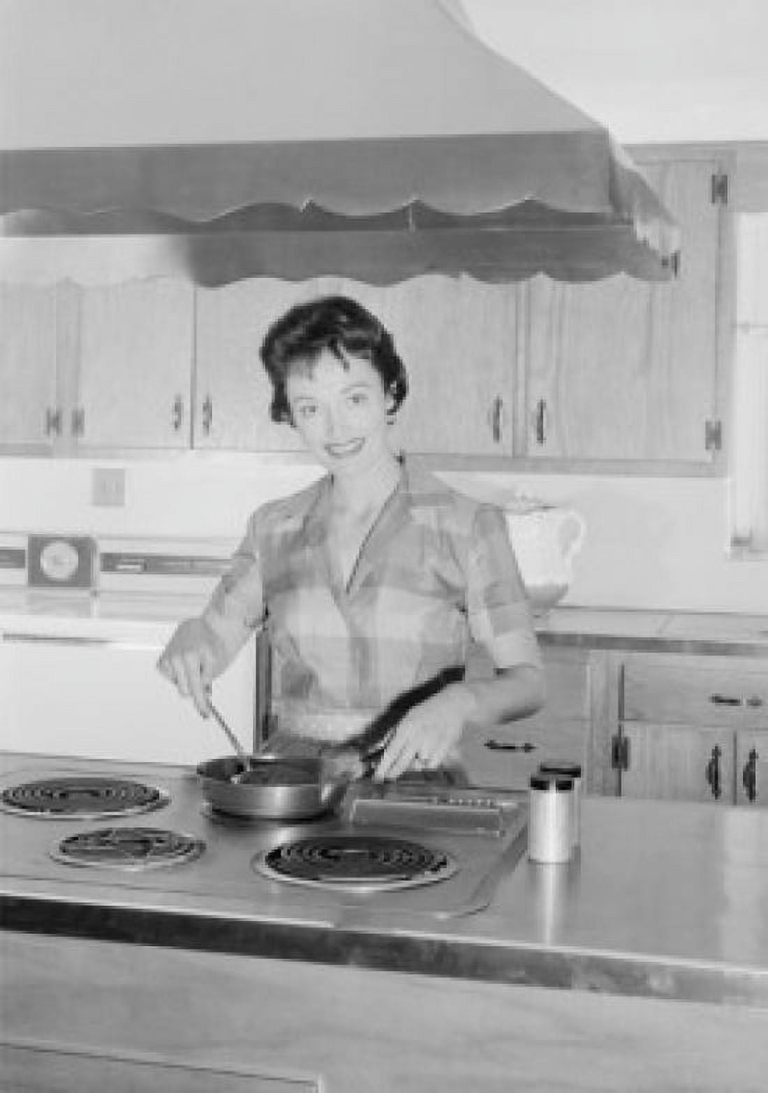 Young woman cooking in kitchen Canvas Art - (18 x 24)