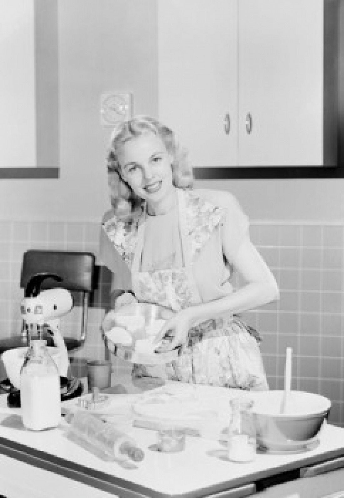 Young woman cooking in kitchen Canvas Art - (24 x 36)