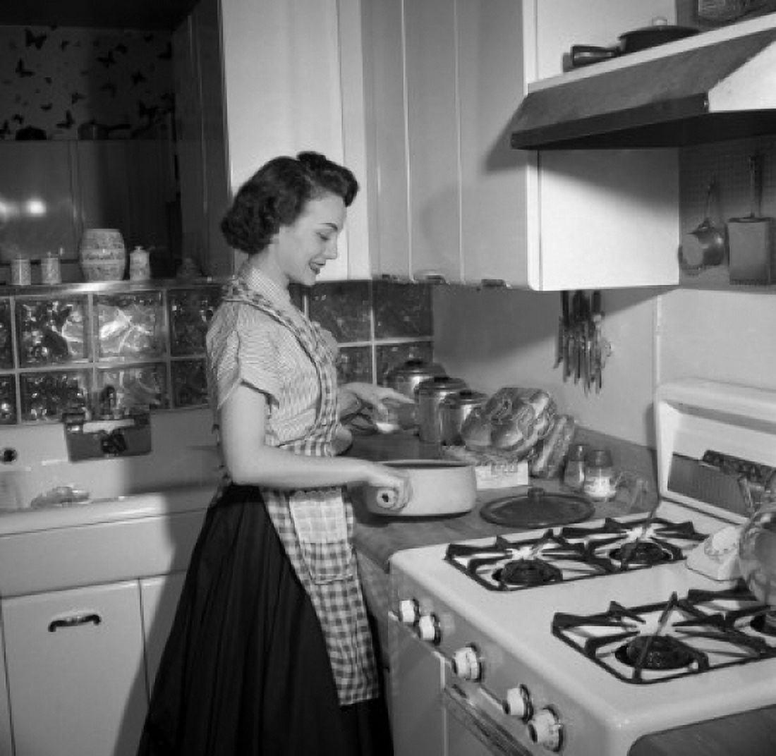 Young woman cooking in kitchen Canvas Art - (24 x 36)