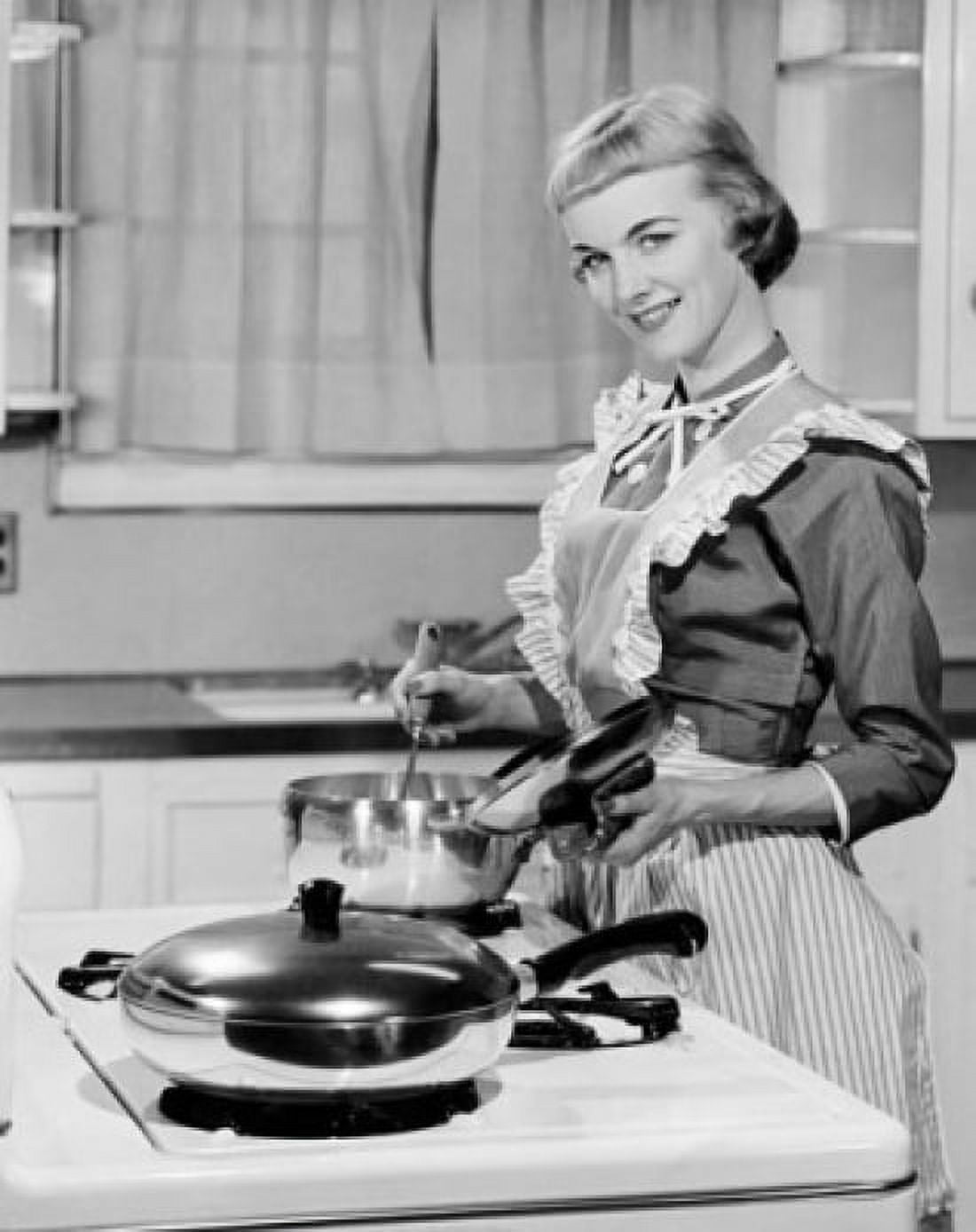 Young woman cooking in kitchen and smiling Canvas Art - (24 x 36)