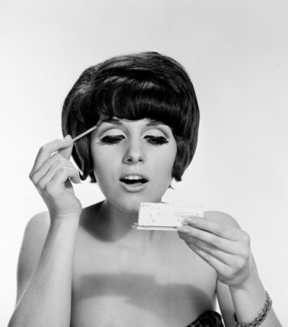 Young woman doing make-up studio shot Canvas Art - (24 x 36)