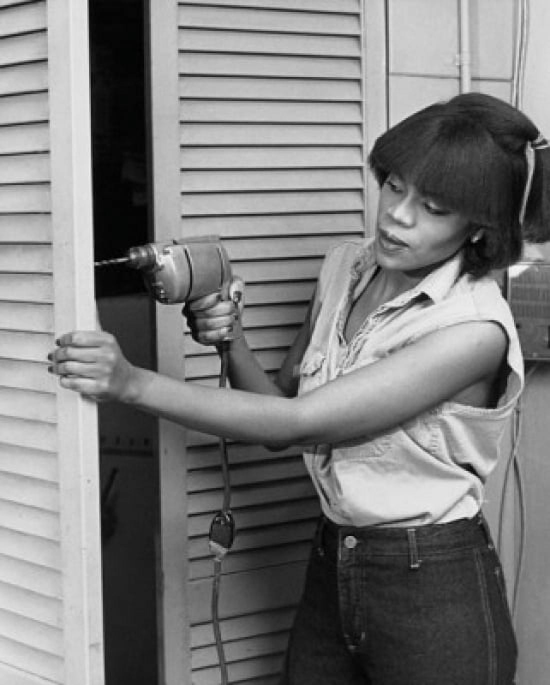 Young woman drilling into a door Canvas Art -  (18 x 24)