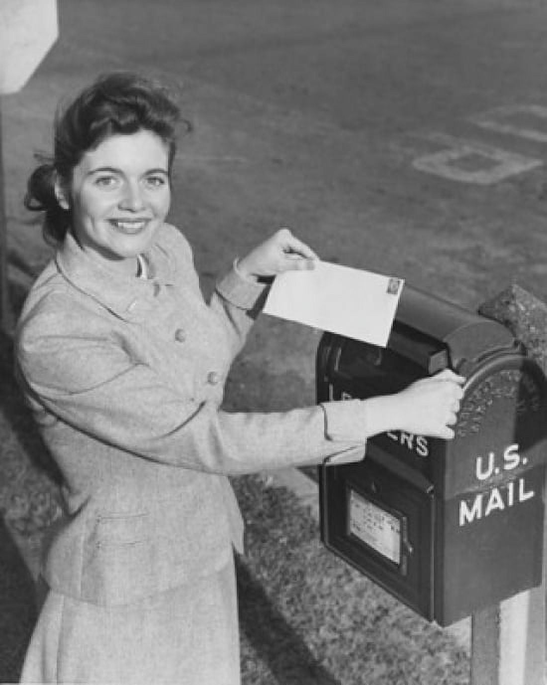 Young woman dropping a letter into a mailbox Canvas Art - (18 x 24)