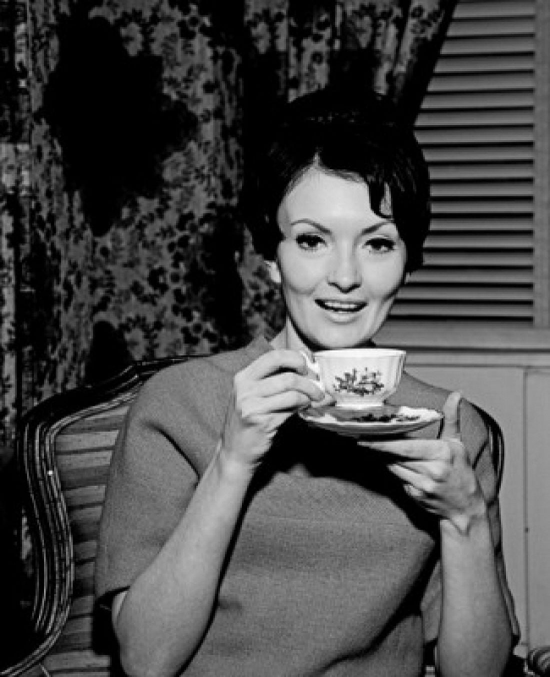 Young woman enjoying cup of tea Canvas Art - (24 x 36)