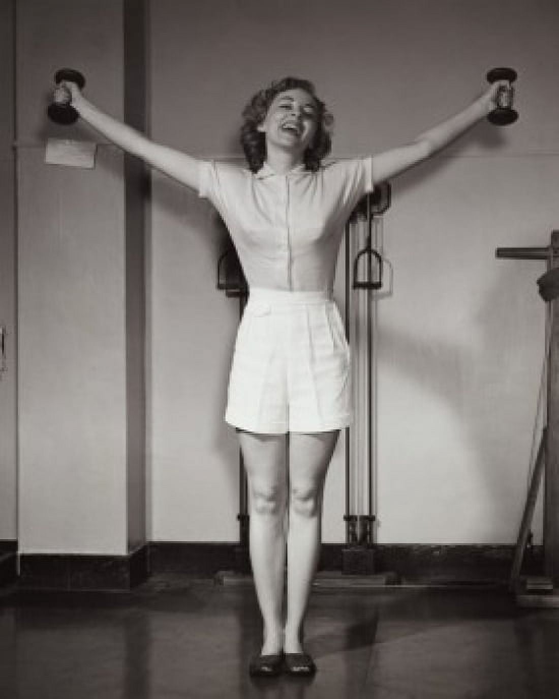 Young woman exercising in a gym and smiling Canvas Art - (18 x 24)