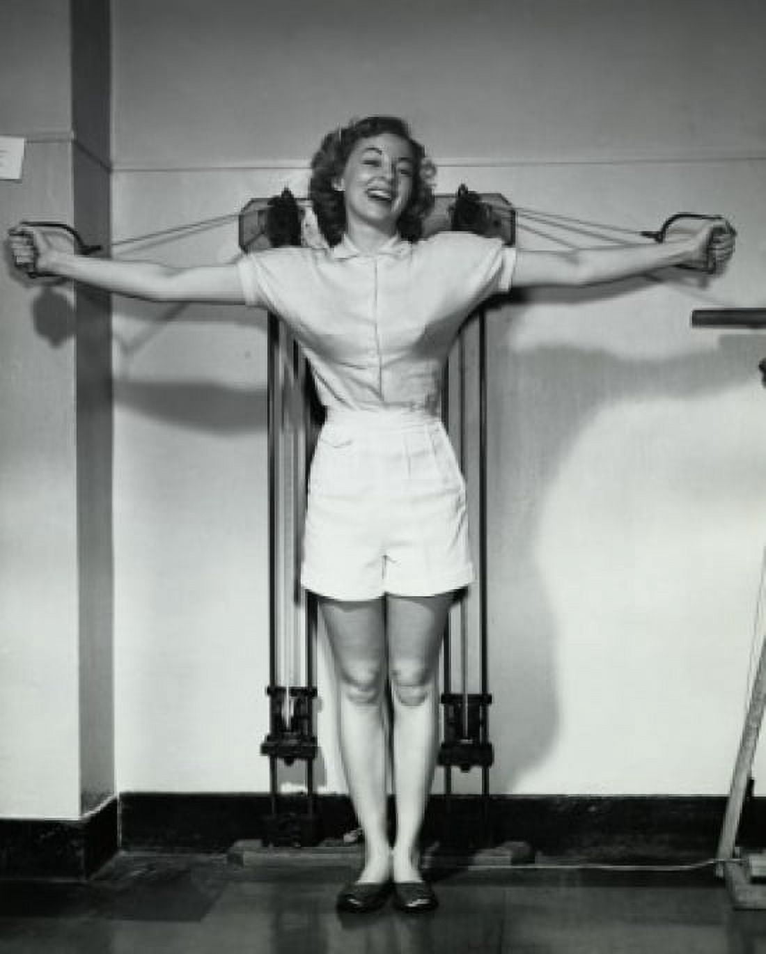 Young woman exercising in a gym and smiling Canvas Art - (18 x 24)
