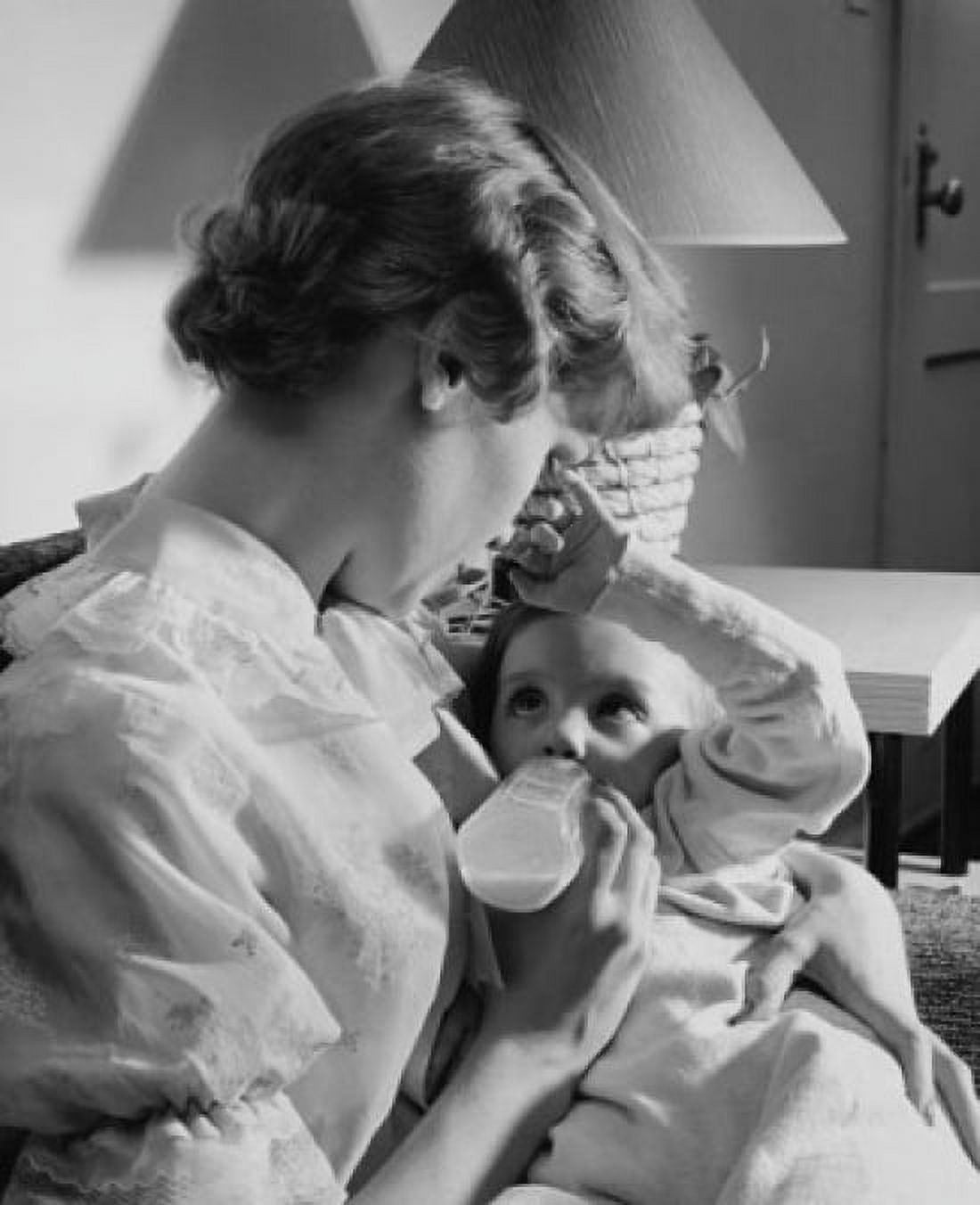 Young woman feeding her baby with a baby bottle Canvas Art - (24 x 36)