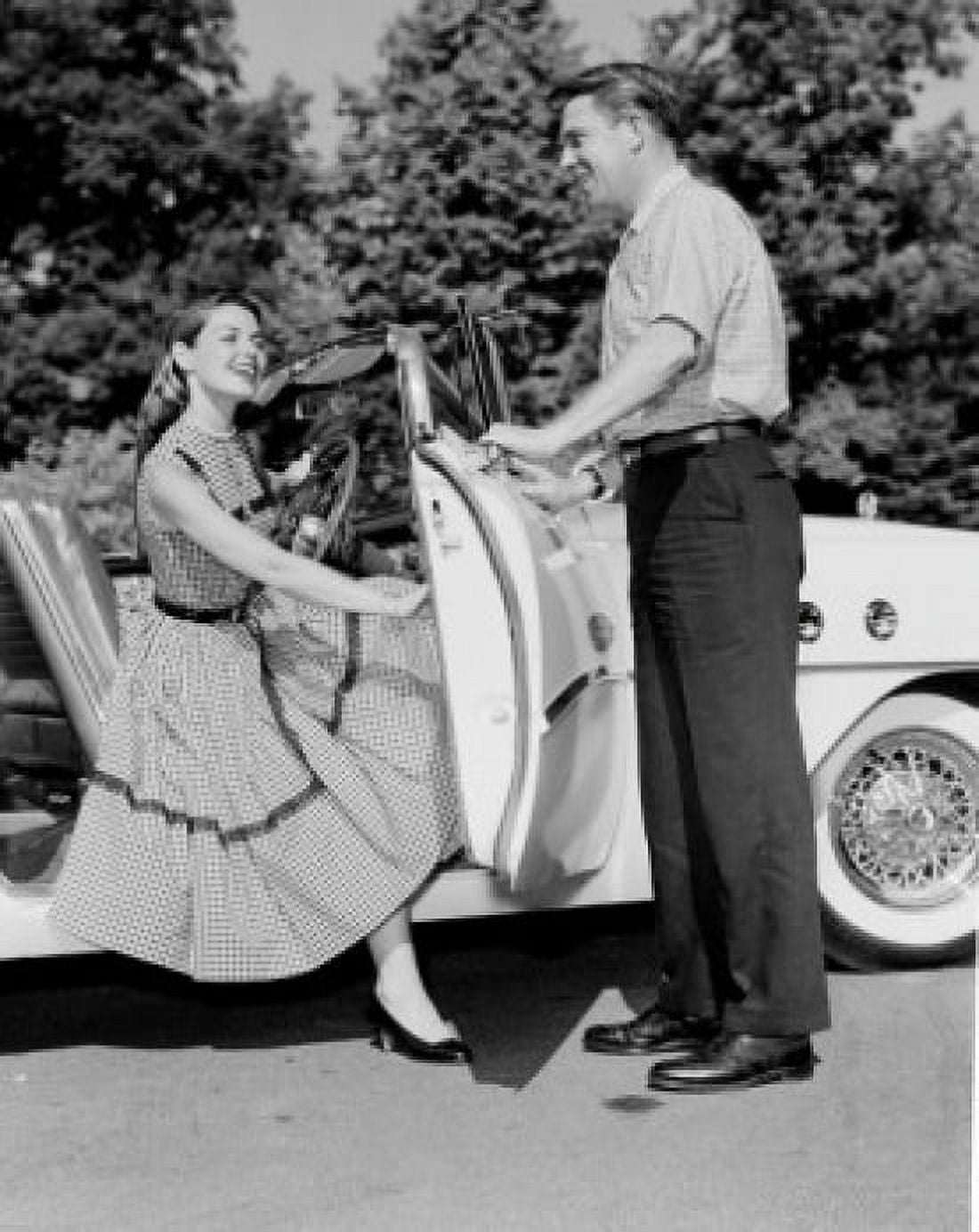 Young woman getting of convertible young man opening car door Canvas Art - (24 x 36)