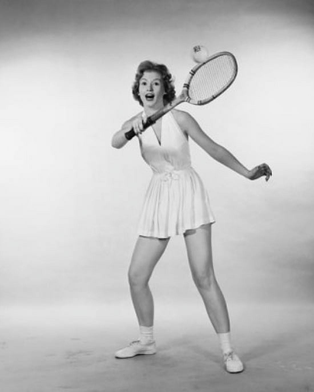 Young woman hitting a tennis ball with a tennis racket Canvas Art - (24 x 36)