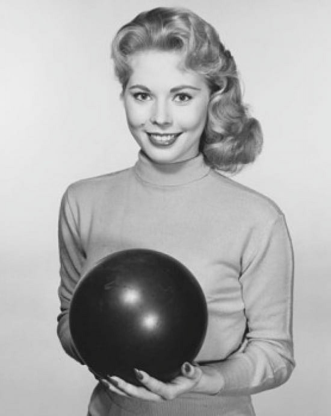 Young woman holding a bowling ball and smiling Canvas Art -  (18 x 24)