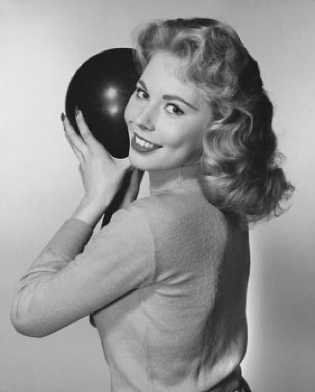 Young woman holding a bowling ball and smiling Canvas Art - (18 x 24)