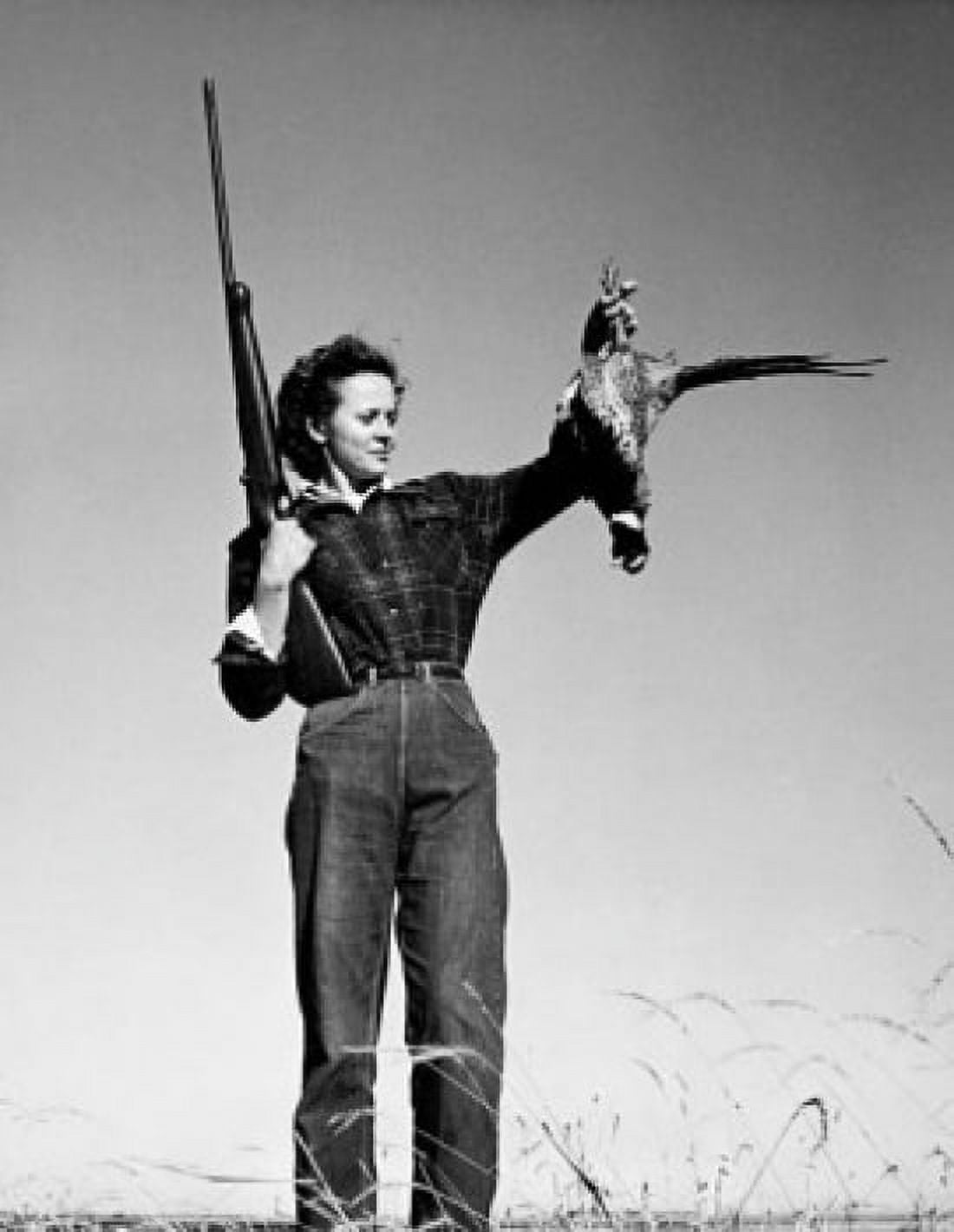 Young woman holding a dead bird and a rifle Canvas Art - (24 x 36)