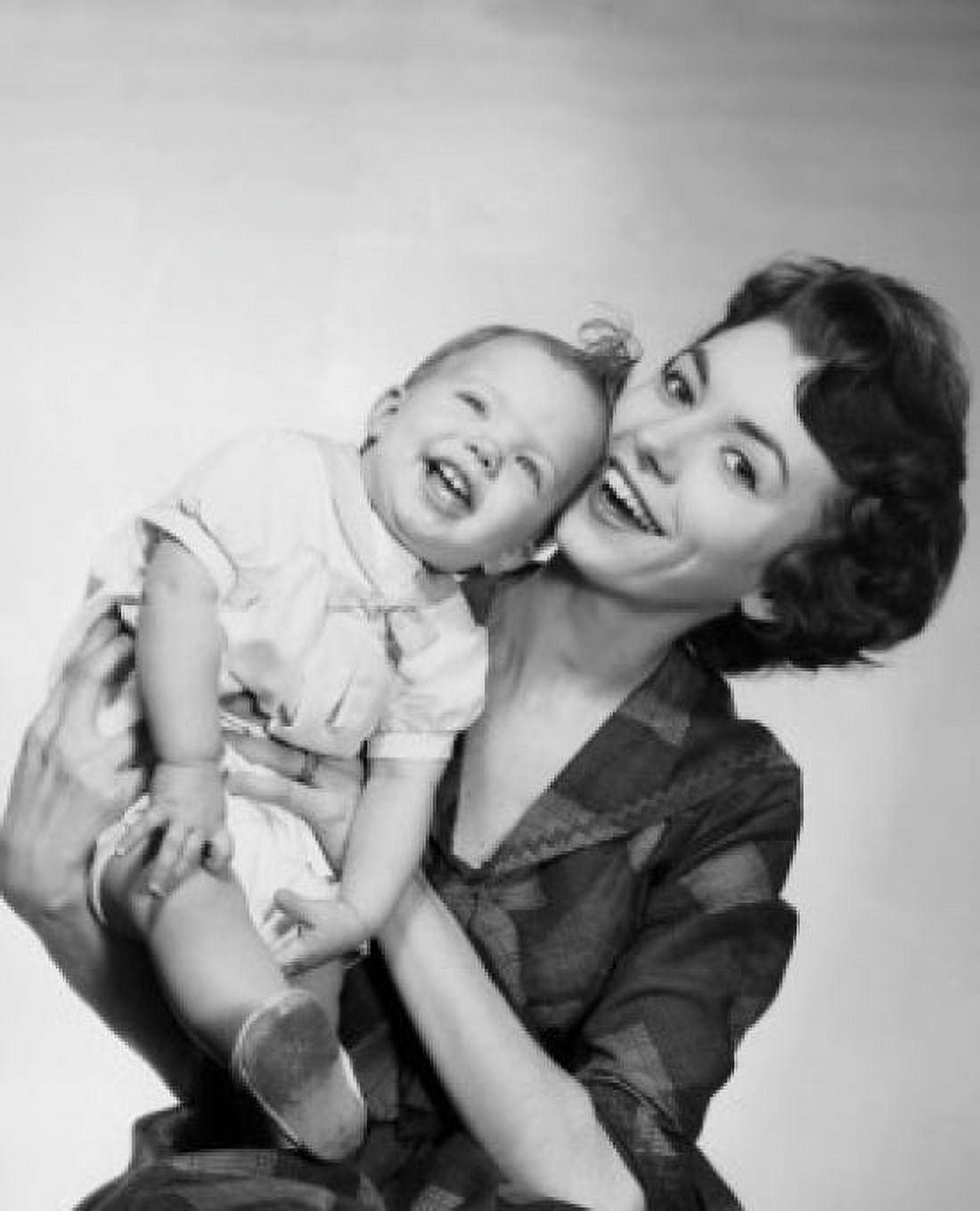 Young woman holding daughter and smiling Canvas Art - (18 x 24)