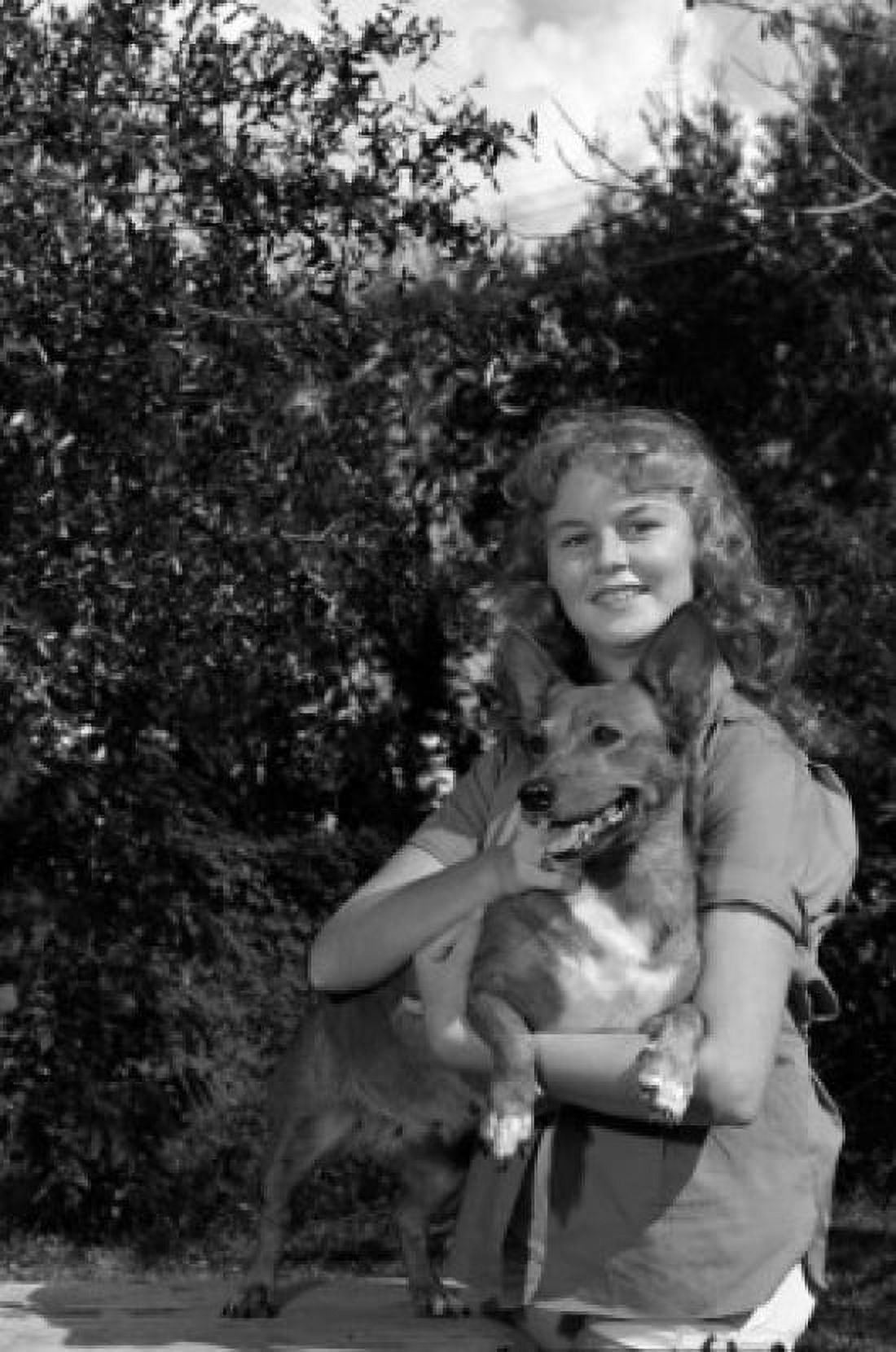 Young woman holding dog and smiling Canvas Art - (18 x 24)