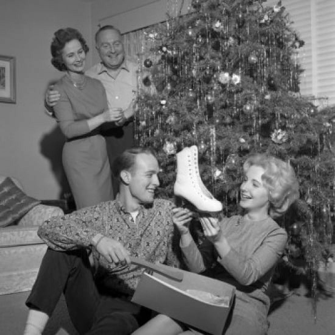Young woman holding new ice skate parents standing near Christmas tree Canvas Art - (24 x 36)