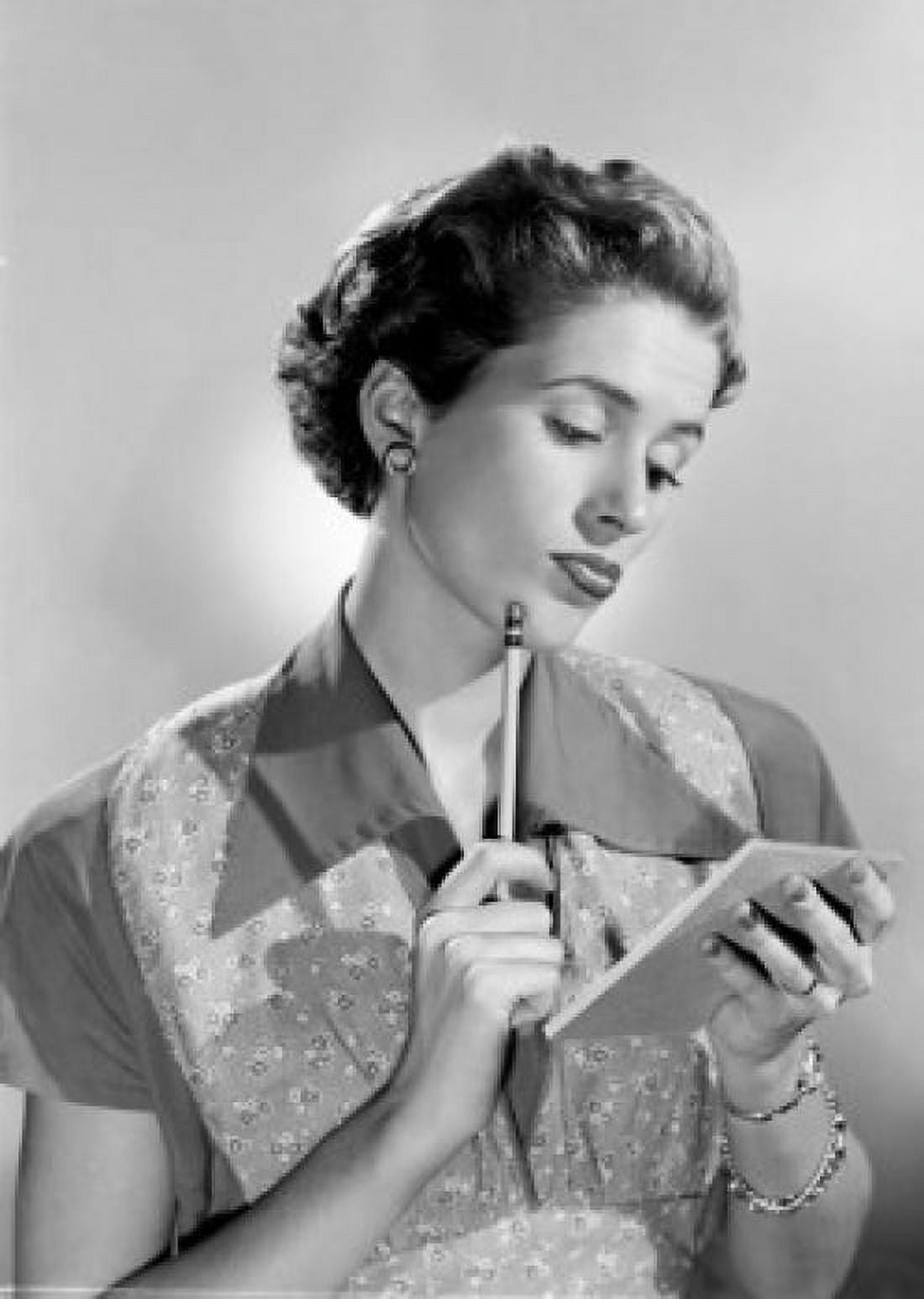 Young woman holding note pad and pencil Canvas Art - (24 x 36)
