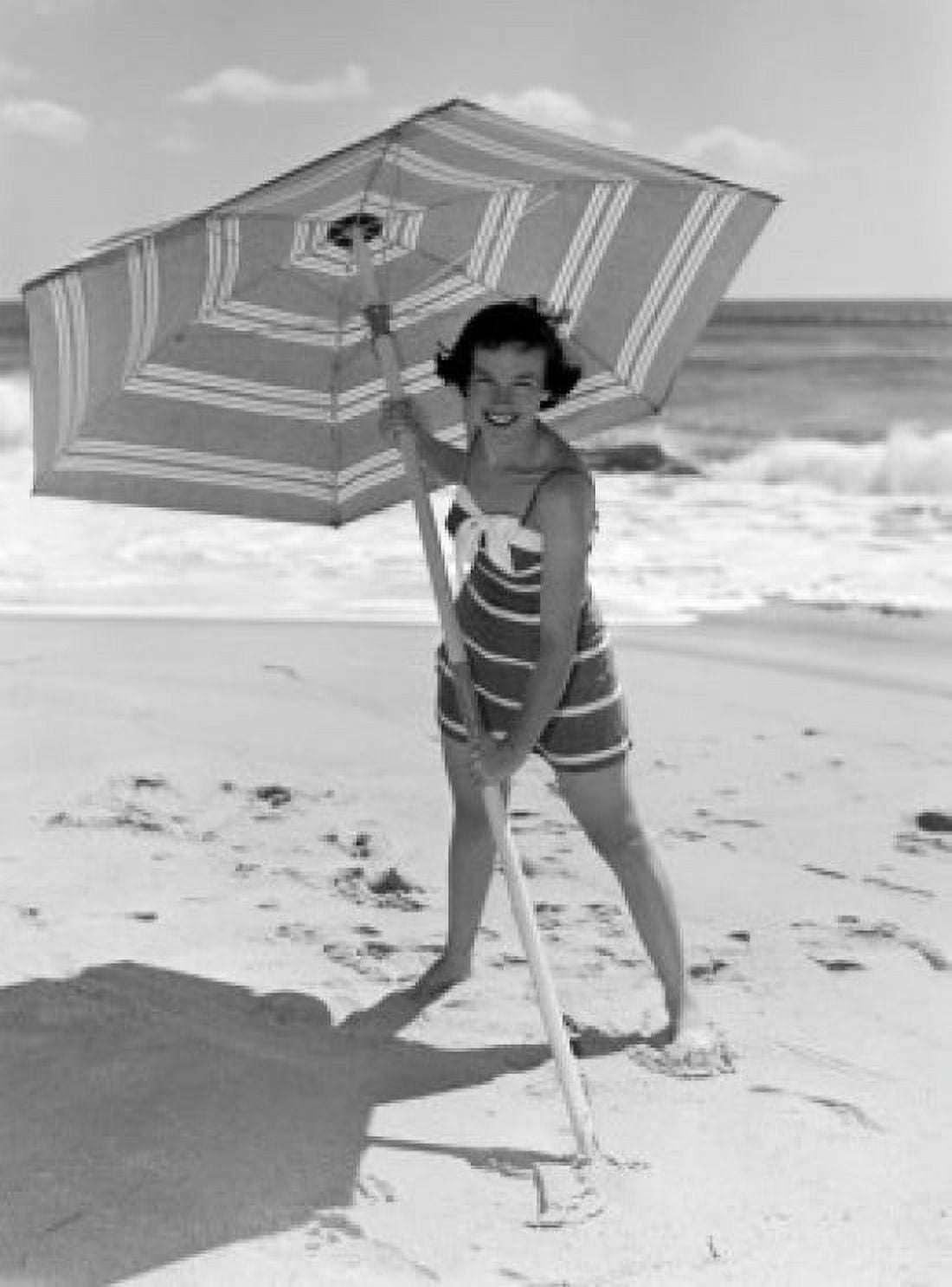 Young woman holding sun umbrella on beach Canvas Art - (18 x 24)