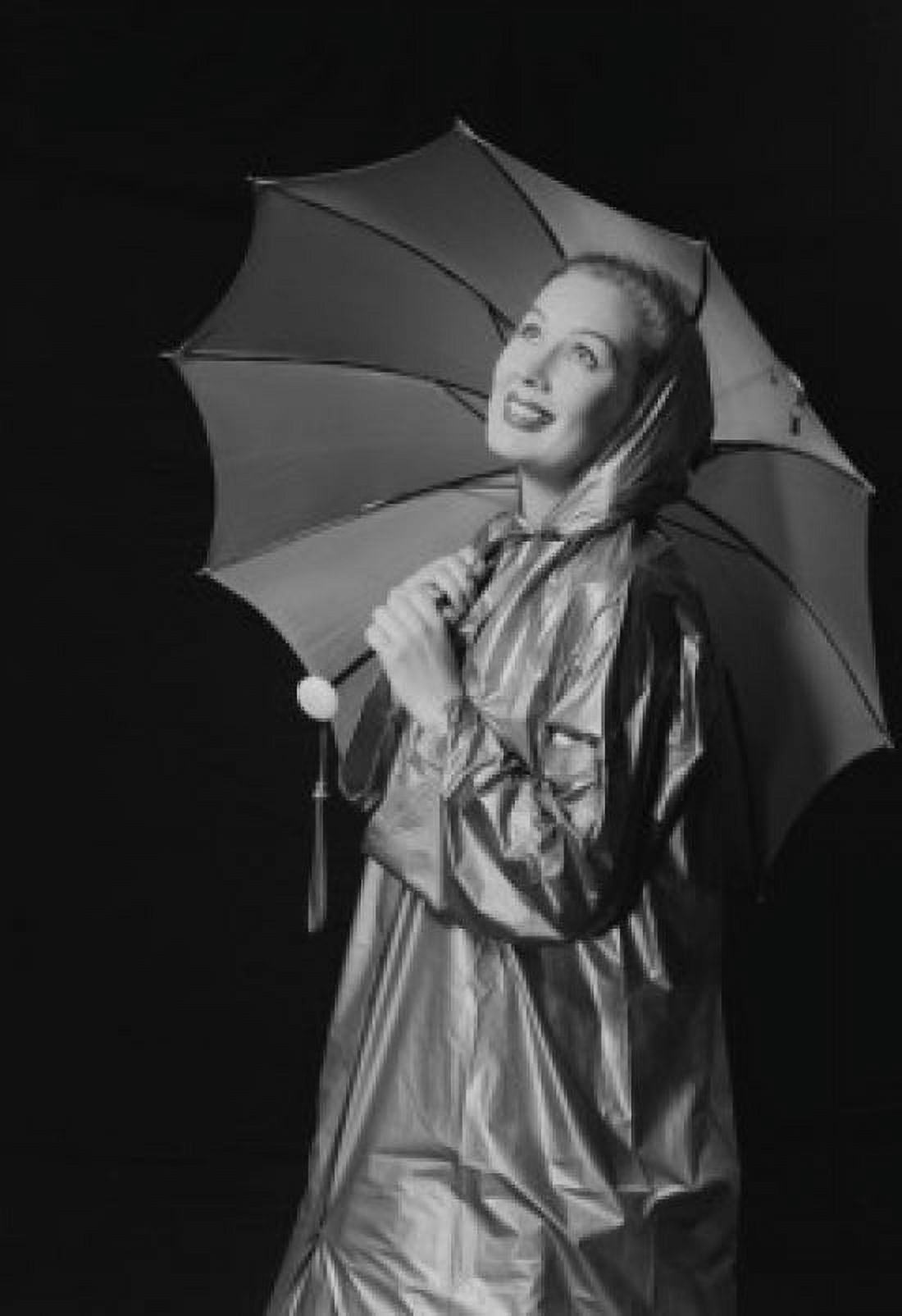 Young woman holding umbrella and wearing raincoat Canvas Art - (18 x 24)