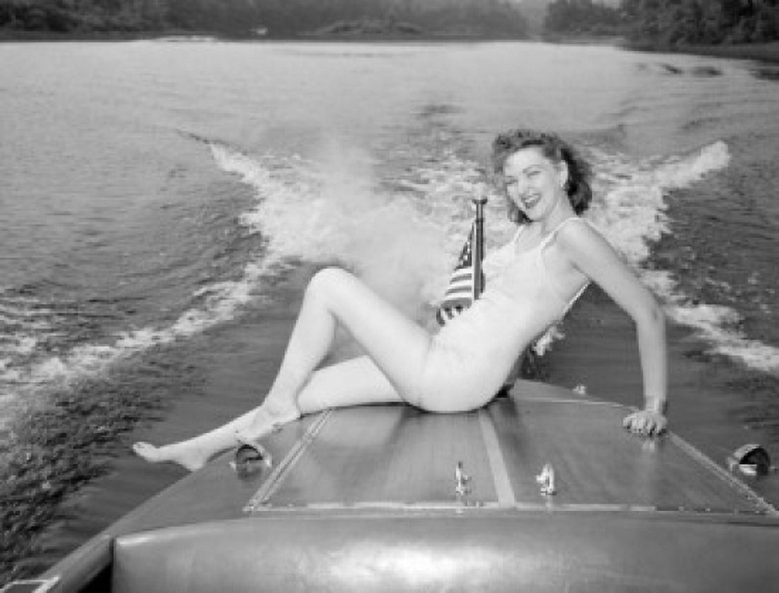 Young woman in bikini sitting on speed boat Canvas Art - (24 x 36)