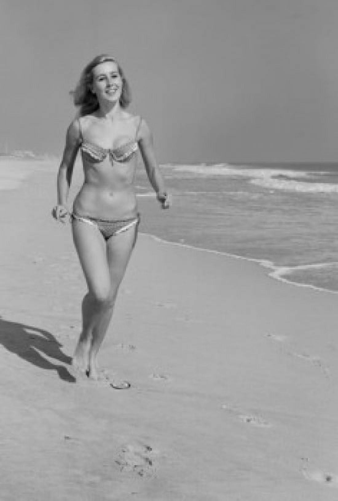 Young woman in bikini walking on beach Canvas Art - (18 x 24)