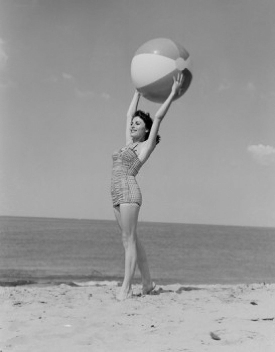 Young woman in swimwear holding beach ball Canvas Art - (24 x 36)