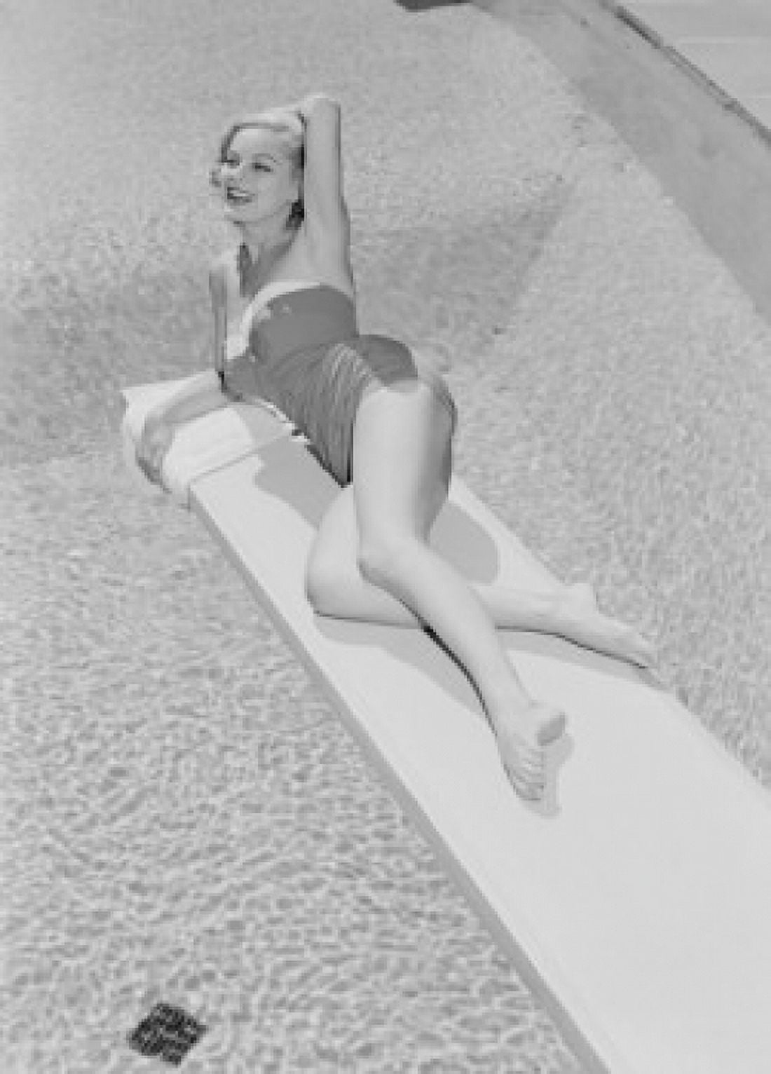 Young woman in swimwear lying on diving board Canvas Art - (24 x 36)