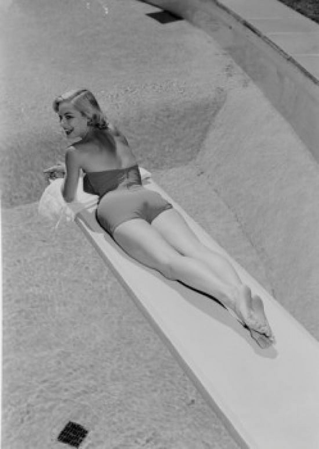 Young woman in swimwear lying on diving board Canvas Art - (24 x 36)