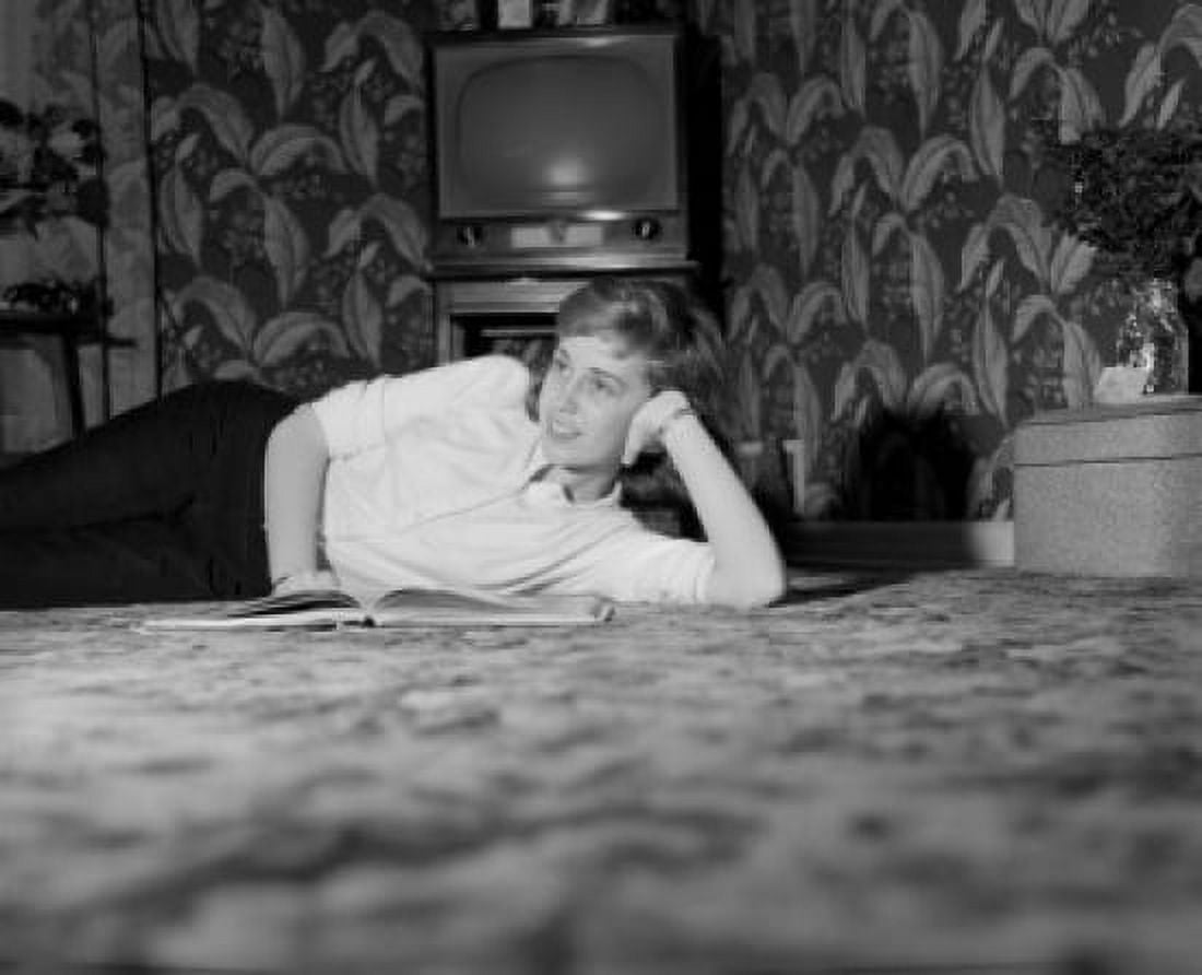 Young woman laying on carpet daydreaming Canvas Art - (24 x 36)