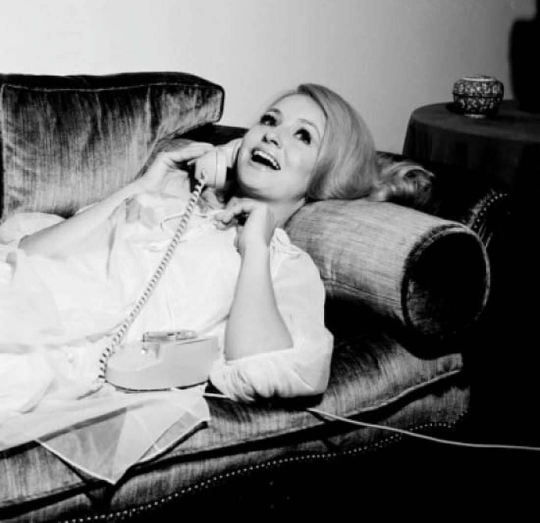 Young woman laying on sofa using telephone Canvas Art - (18 x 24)