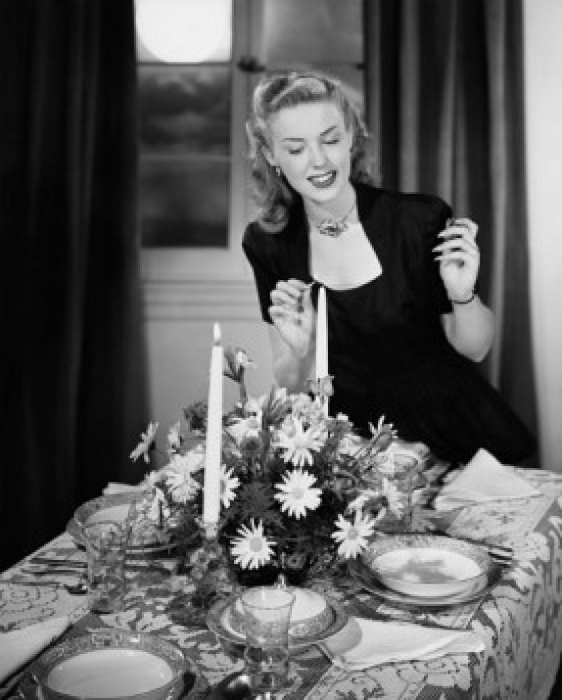 Young woman lighting candle at dining table Canvas Art - (18 x 24)