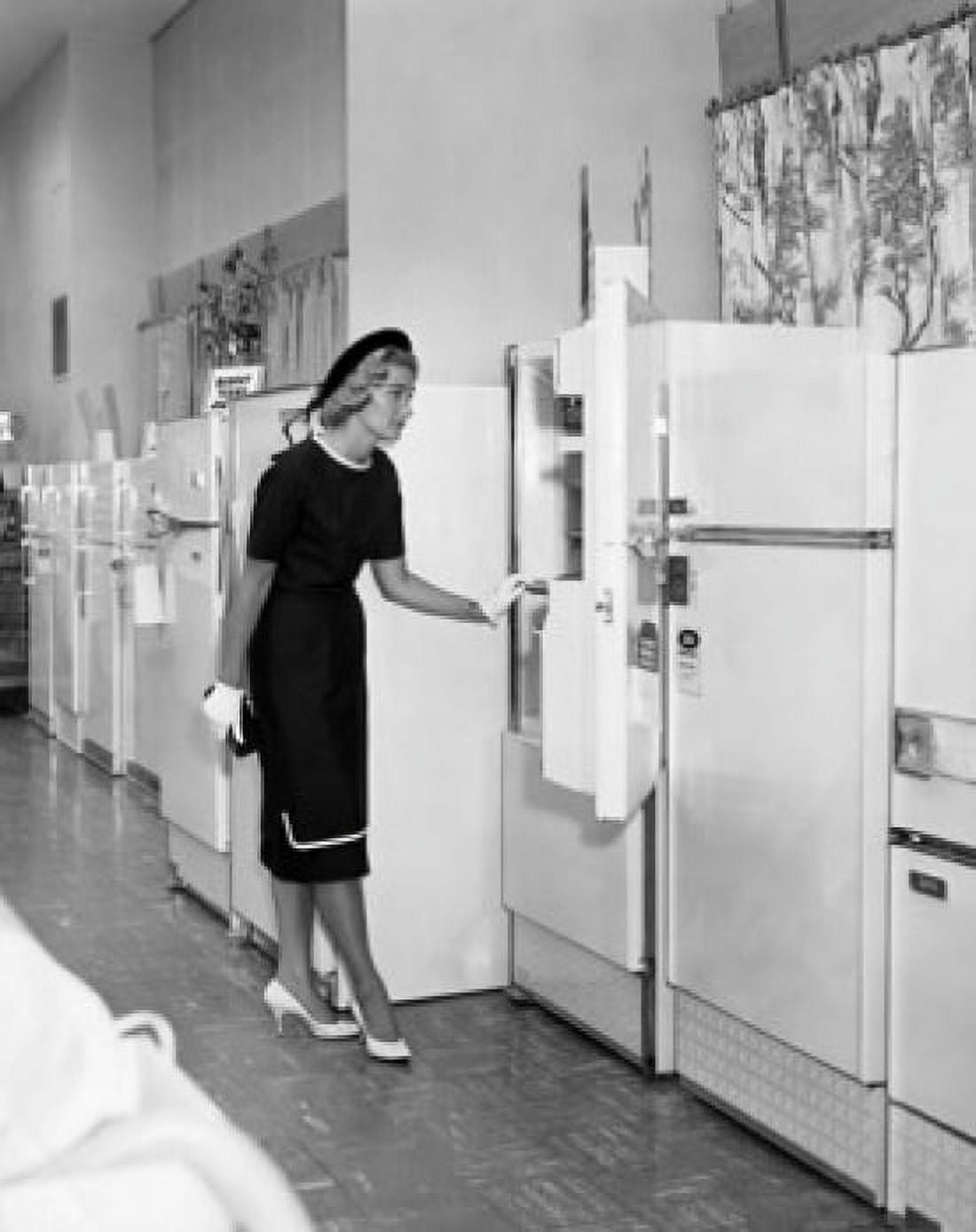 Young woman looking at refrigerators in a store Canvas Art - (24 x 36)