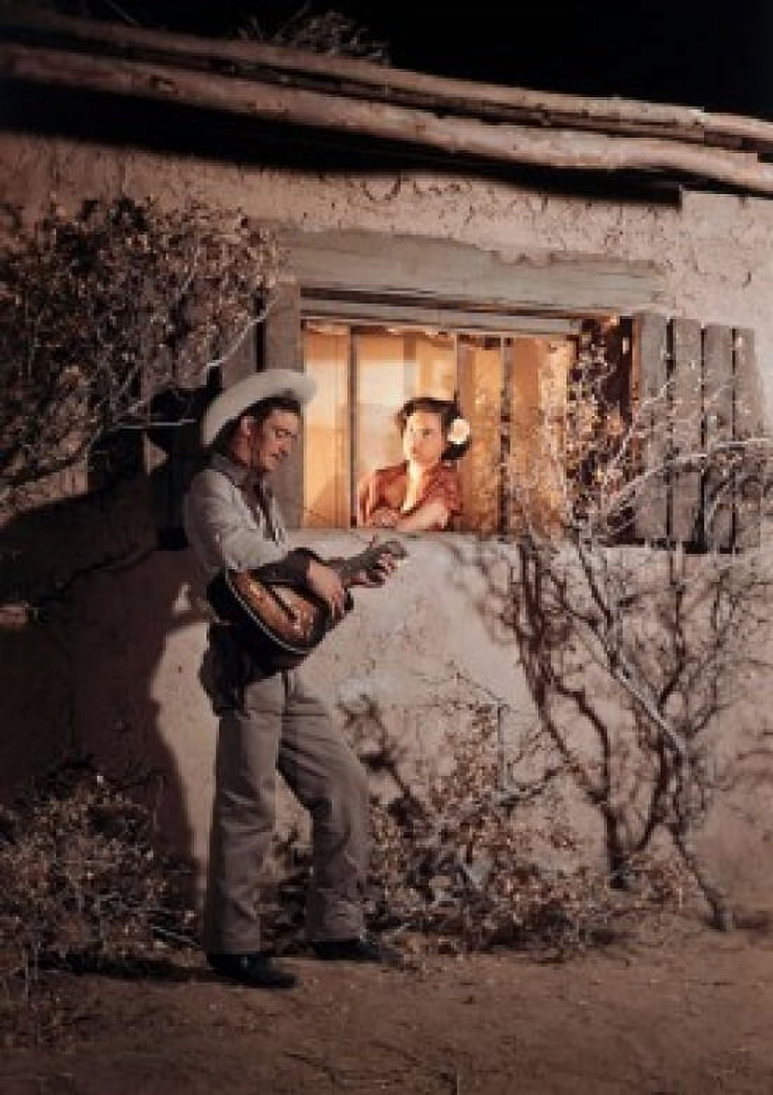 Young woman looking out window at man playing guitar Canvas Art - (18 x 24)