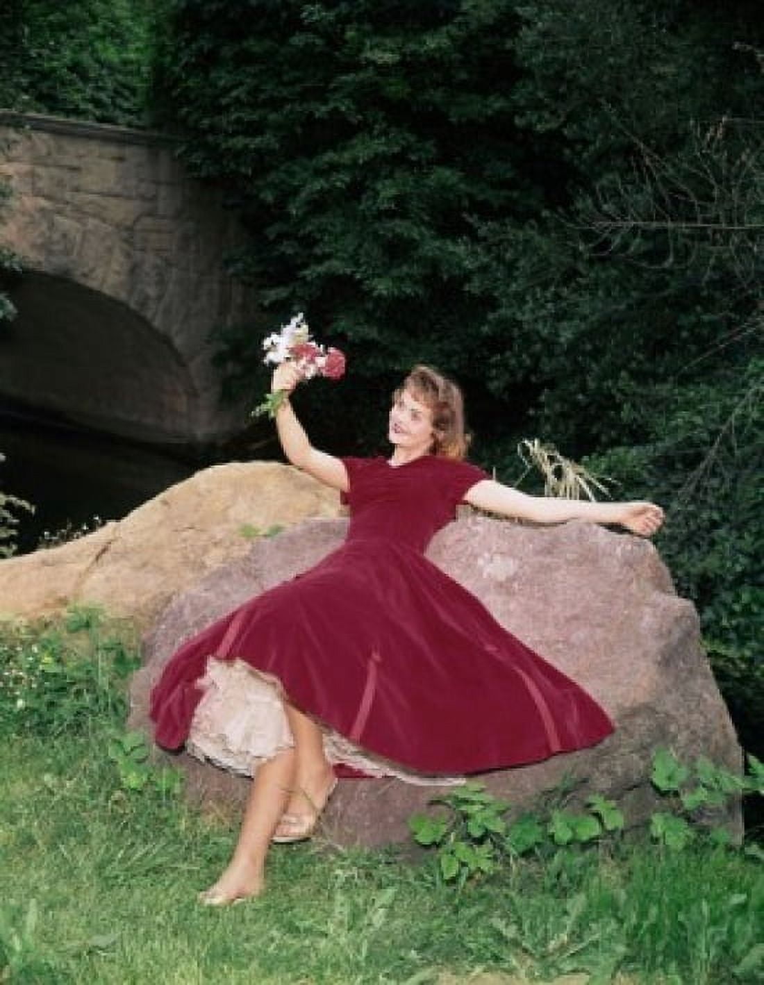 Young woman lying on a rock and holding a bunch of flowers Canvas Art - (18 x 24)