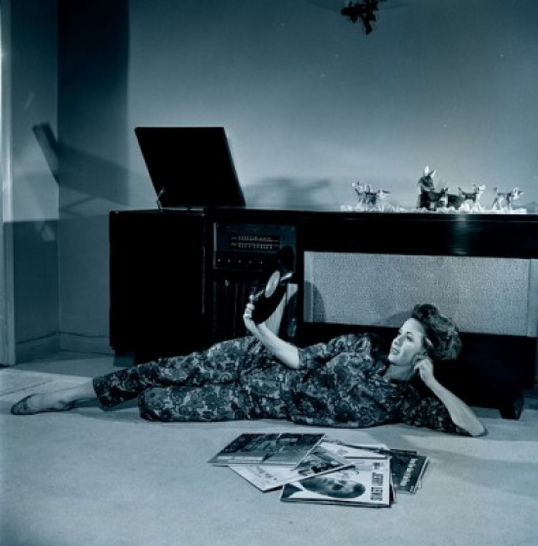 Young woman lying on floor holding record Canvas Art - (18 x 24)
