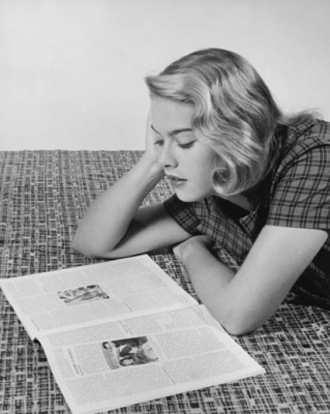 Young woman lying on the floor and reading a magazine Canvas Art - (18 x 24)