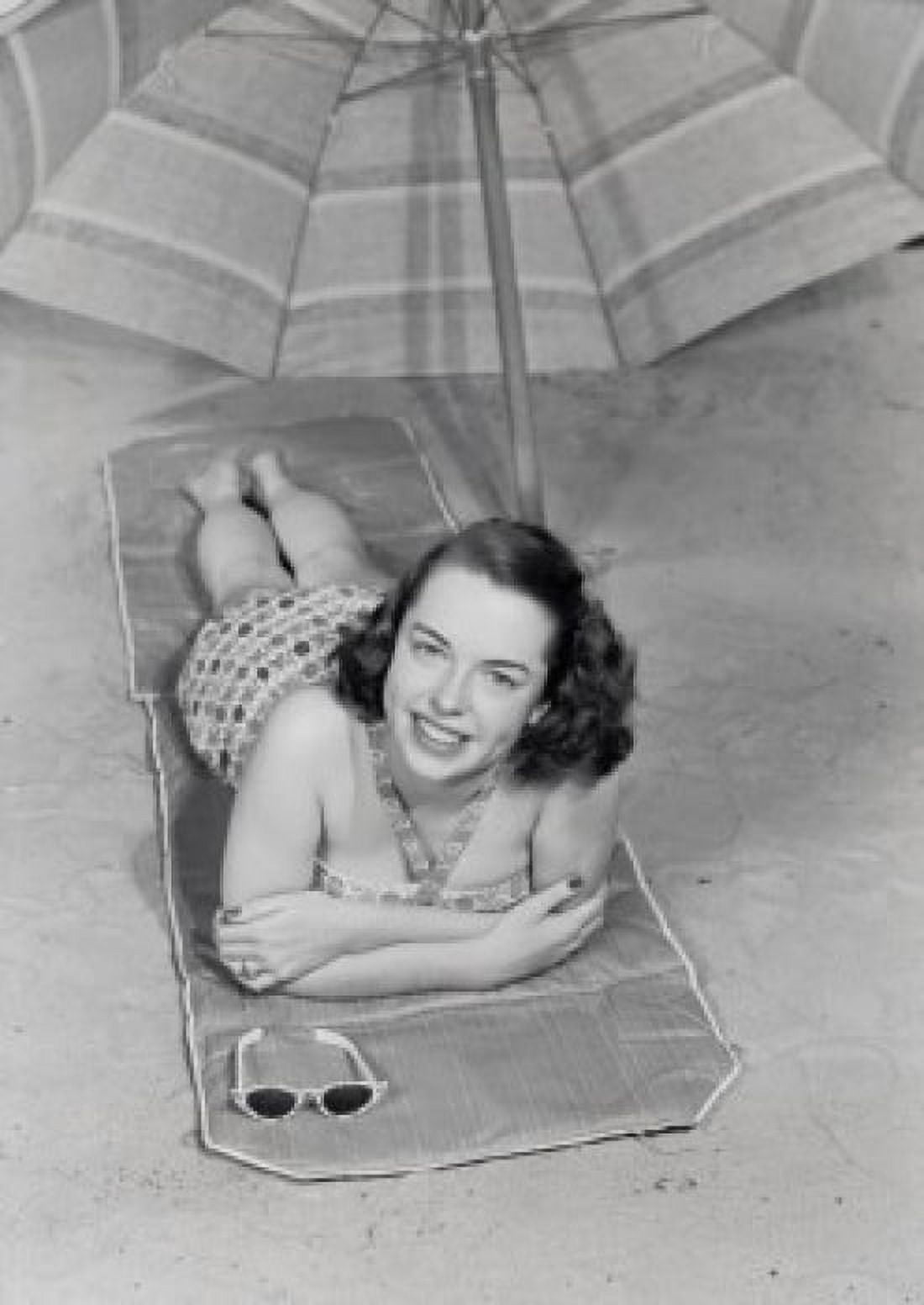 Young woman lying under beach umbrella Canvas Art - (18 x 24)