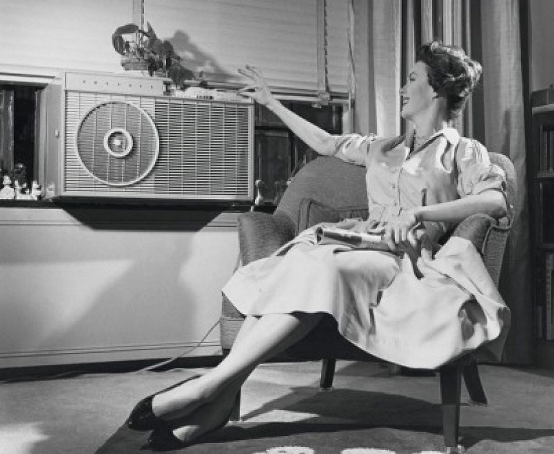 Young woman operating air conditioner Canvas Art - (18 x 24)