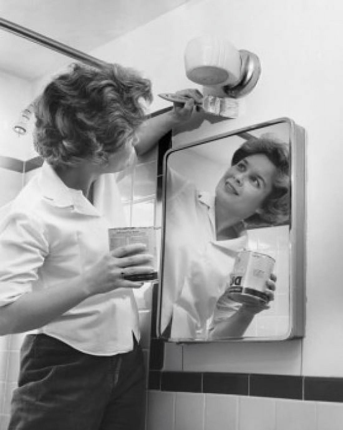 Young woman painting a wall in the bathroom Canvas Art - (18 x 24)