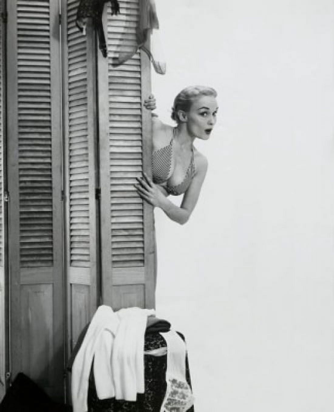 Young woman peeking from behind a screen partition Canvas Art - (18 x 24)