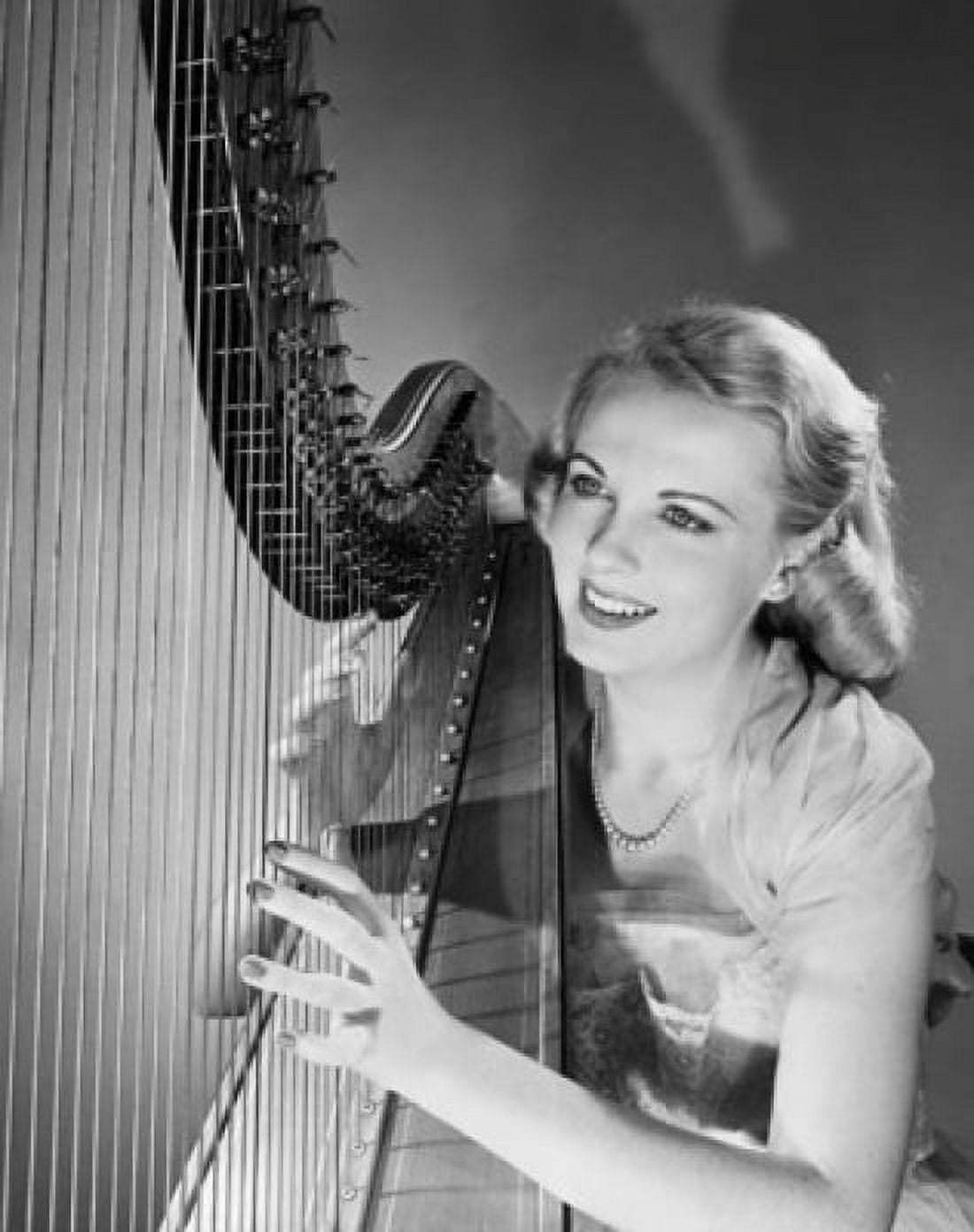 Young woman playing a harp and smiling Canvas Art - (18 x 24)