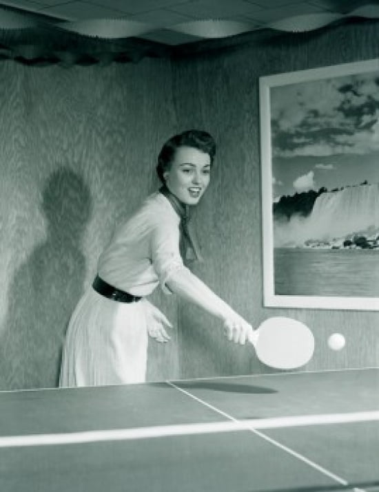 Young woman playing table tennis in home Canvas Art - (18 x 24)