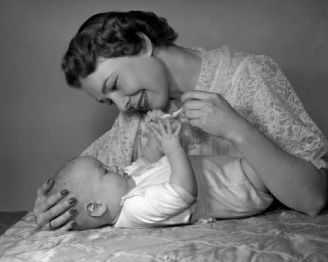 Young woman playing with baby on bed Canvas Art - (18 x 24)