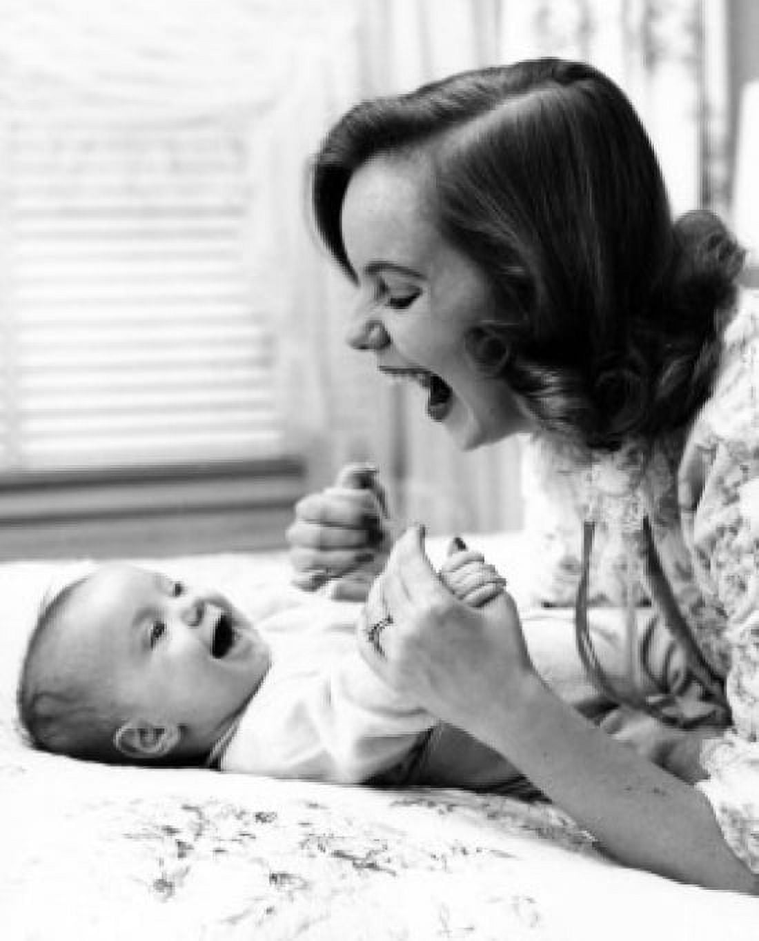 Young woman playing with baby on bed Canvas Art - (24 x 36)