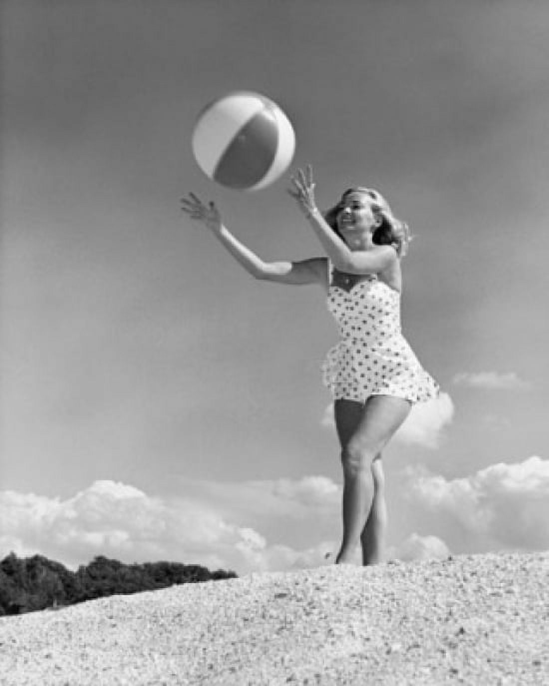 Young woman playing with beach ball Canvas Art - (24 x 36)