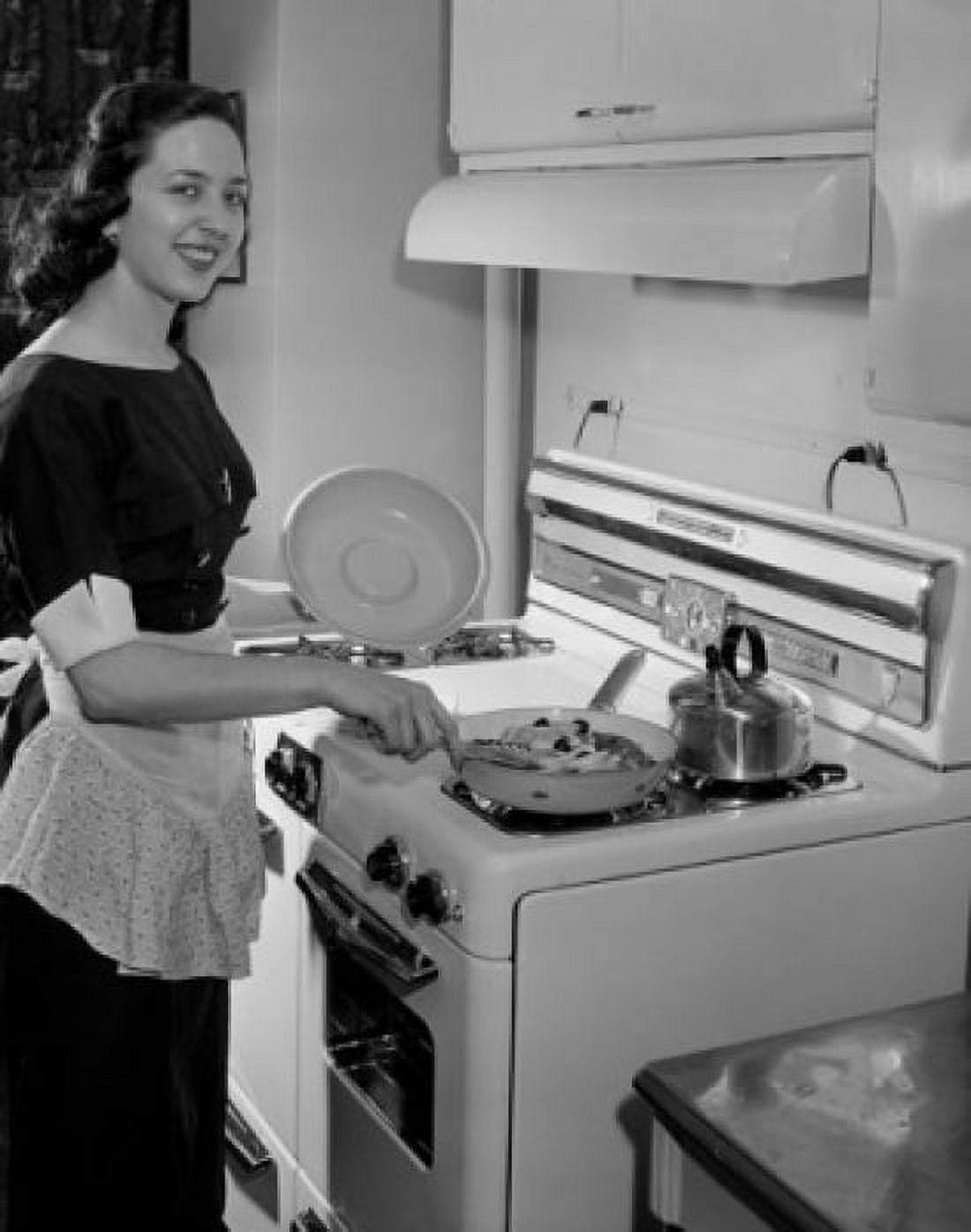Young woman preparing meal in kitchen Canvas Art - (24 x 36)
