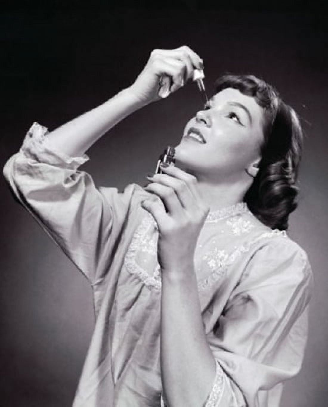 Young woman putting eye drops in her eye Canvas Art - (18 x 24)