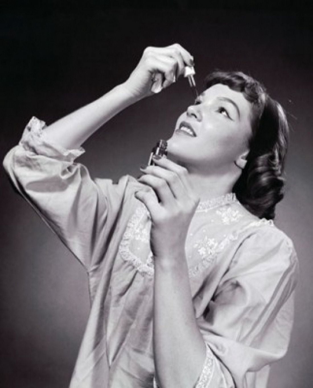 Young woman putting eye drops in her eye Canvas Art - (24 x 36)