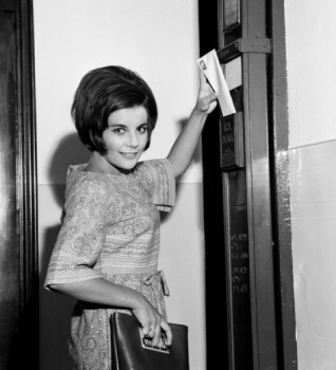 Young woman putting letter in letter box Canvas Art - (18 x 24)